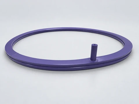 Angled view of a purple ring seal with a silicone air inlet and grooved profile.
